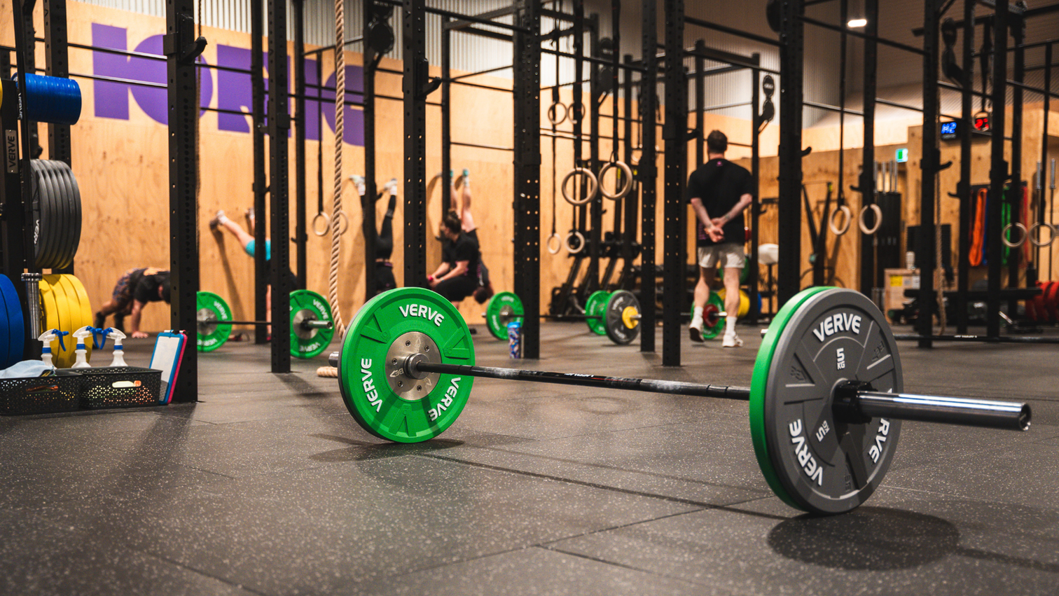 A fitted-out independent gym floor with strength equipment arranged in zones