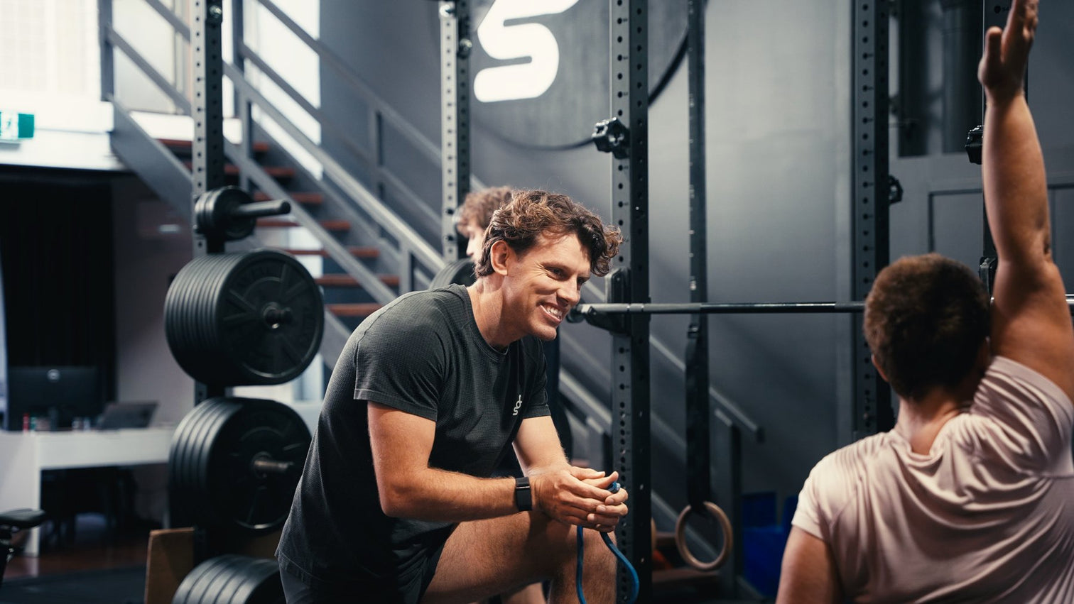 Two coaches talking on the floor of a VERVE-equipped gym