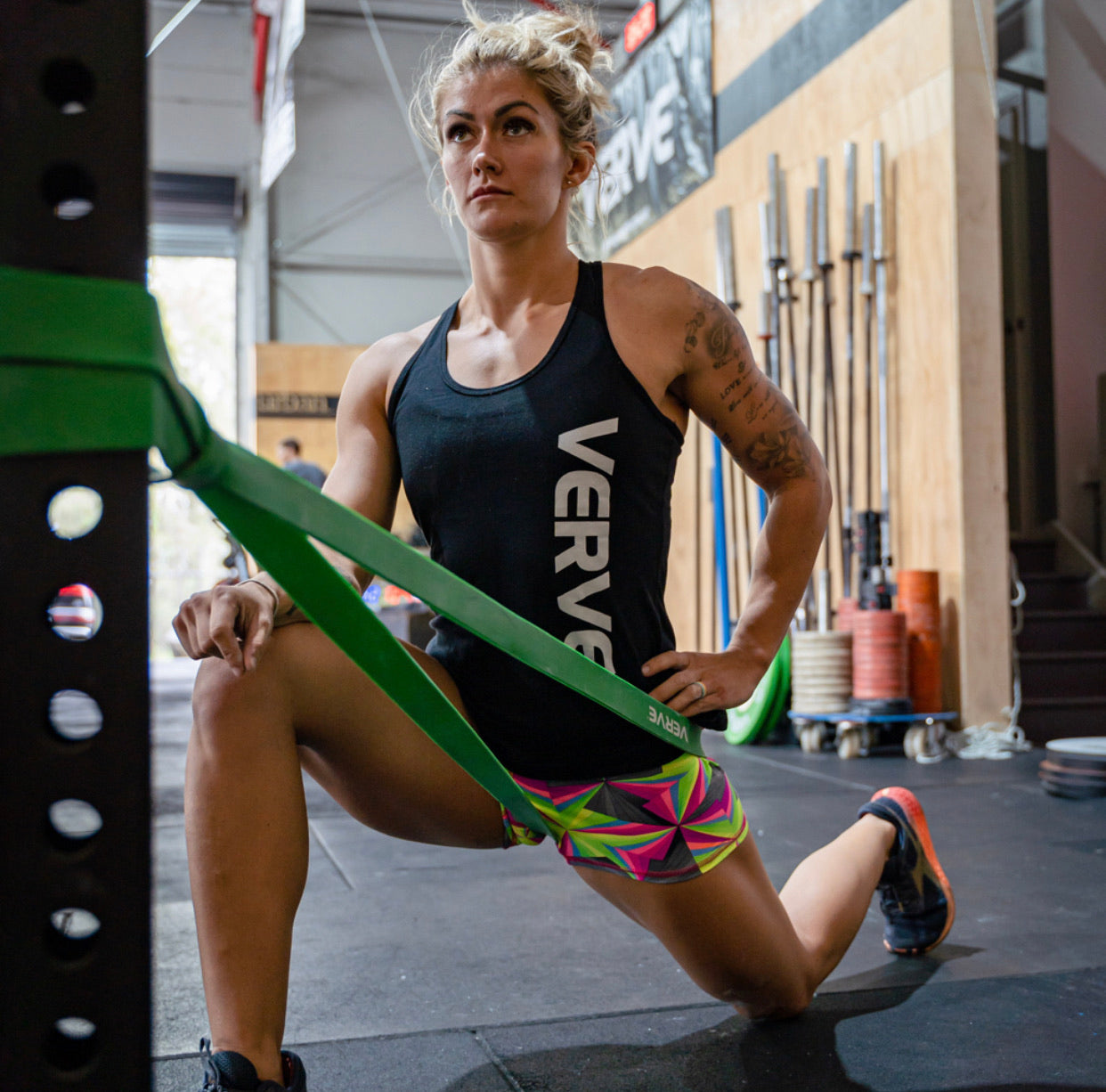 Athlete training with a green VERVE resistance band anchored to a rig