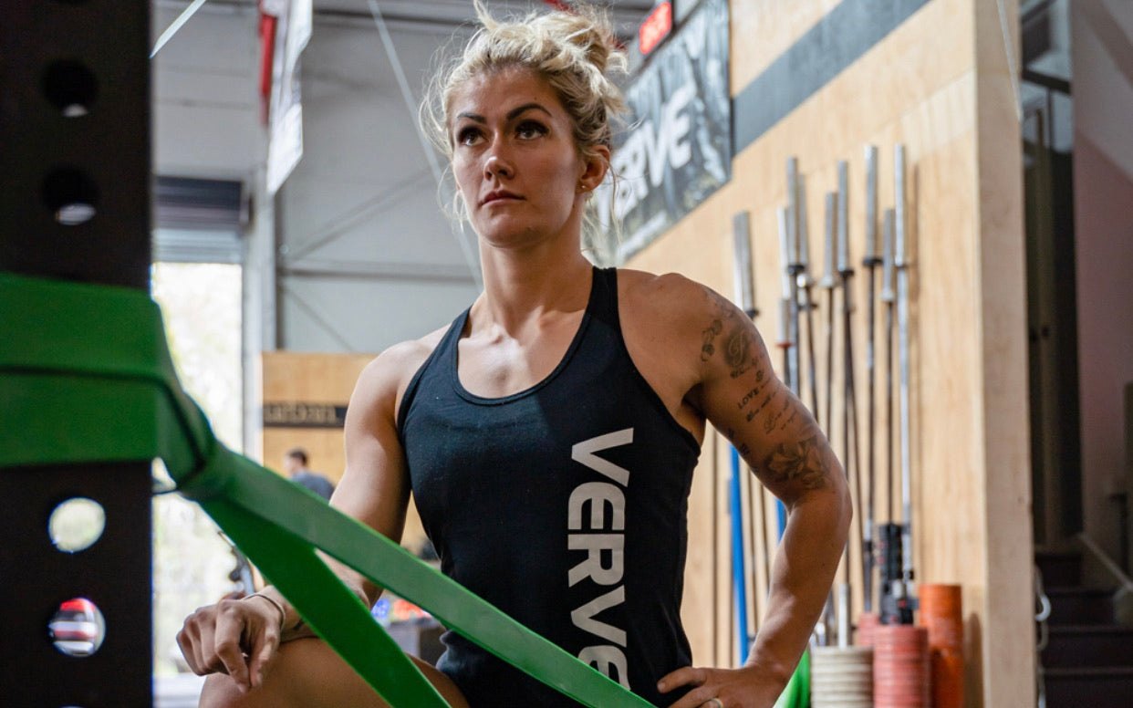 Athlete training with a green VERVE resistance band anchored to a rig