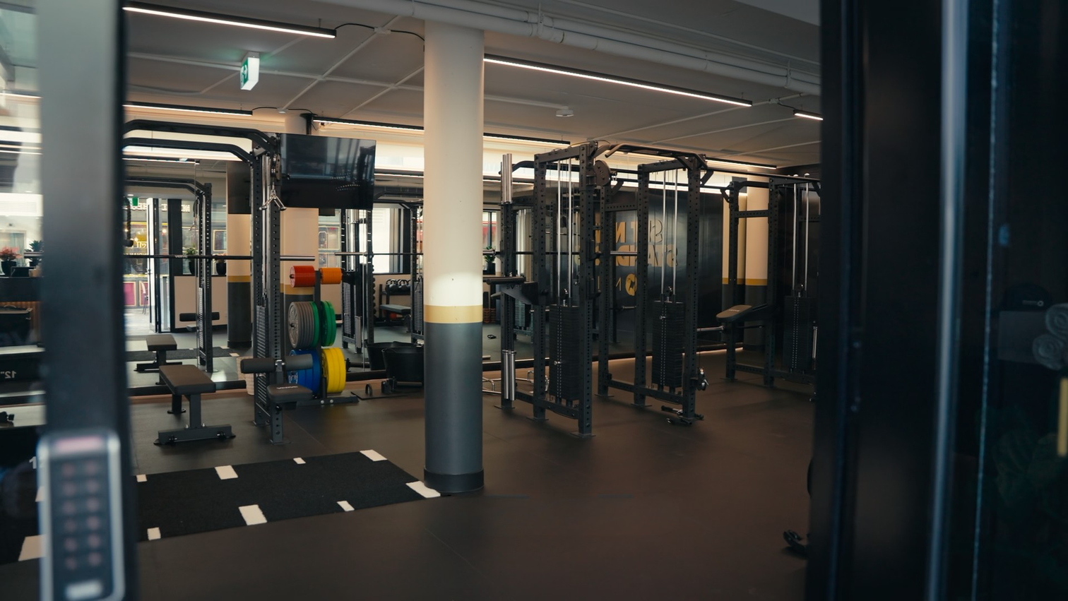 A completed VERVE gym fit-out with rubber flooring, racks and a functional turf strip