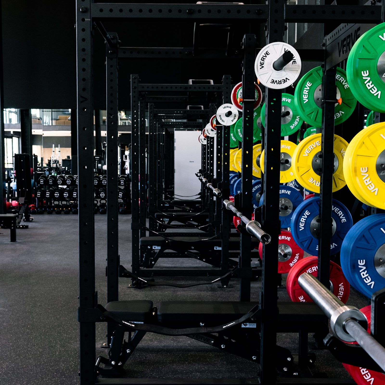 Coaches and members on the floor of a high-performance training facility