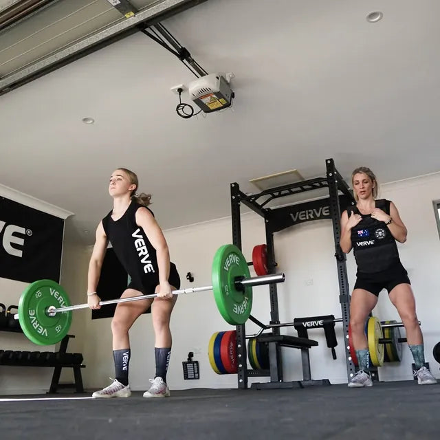 Two people lifting in a VERVE home garage gym